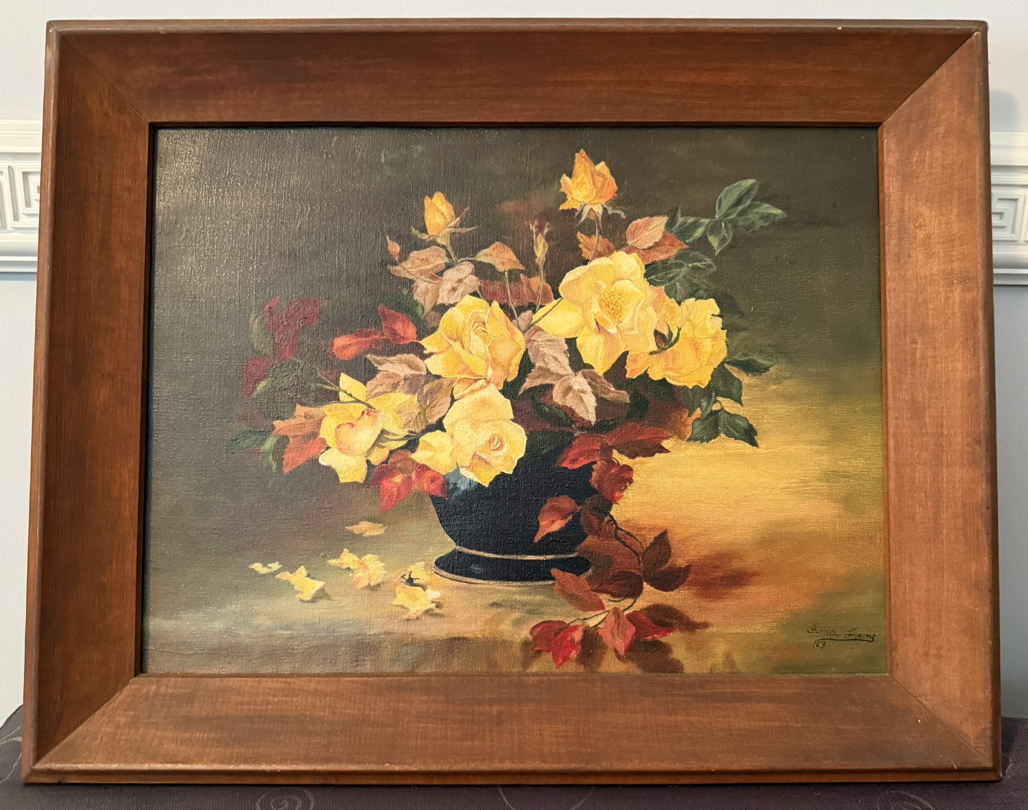 A painting of flowers in a wooden frame

AI-generated content may be incorrect.